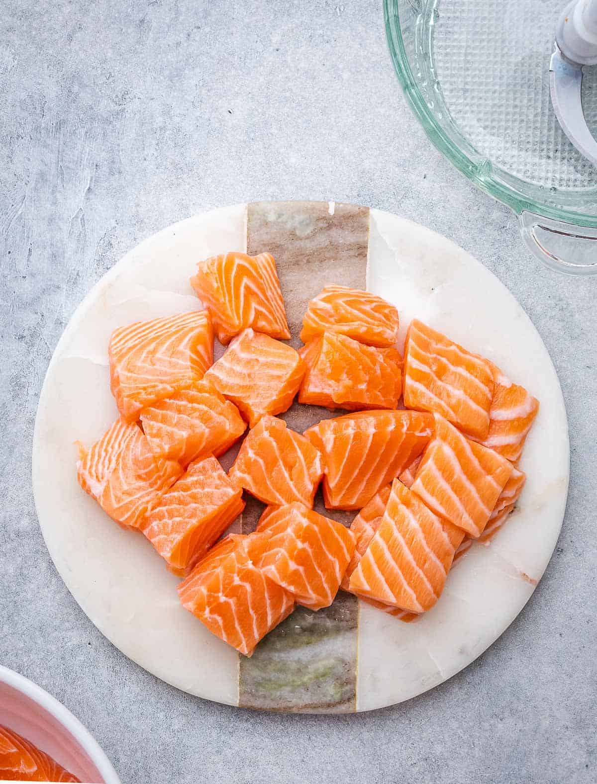 Chunks of fresh salmon on a plate.