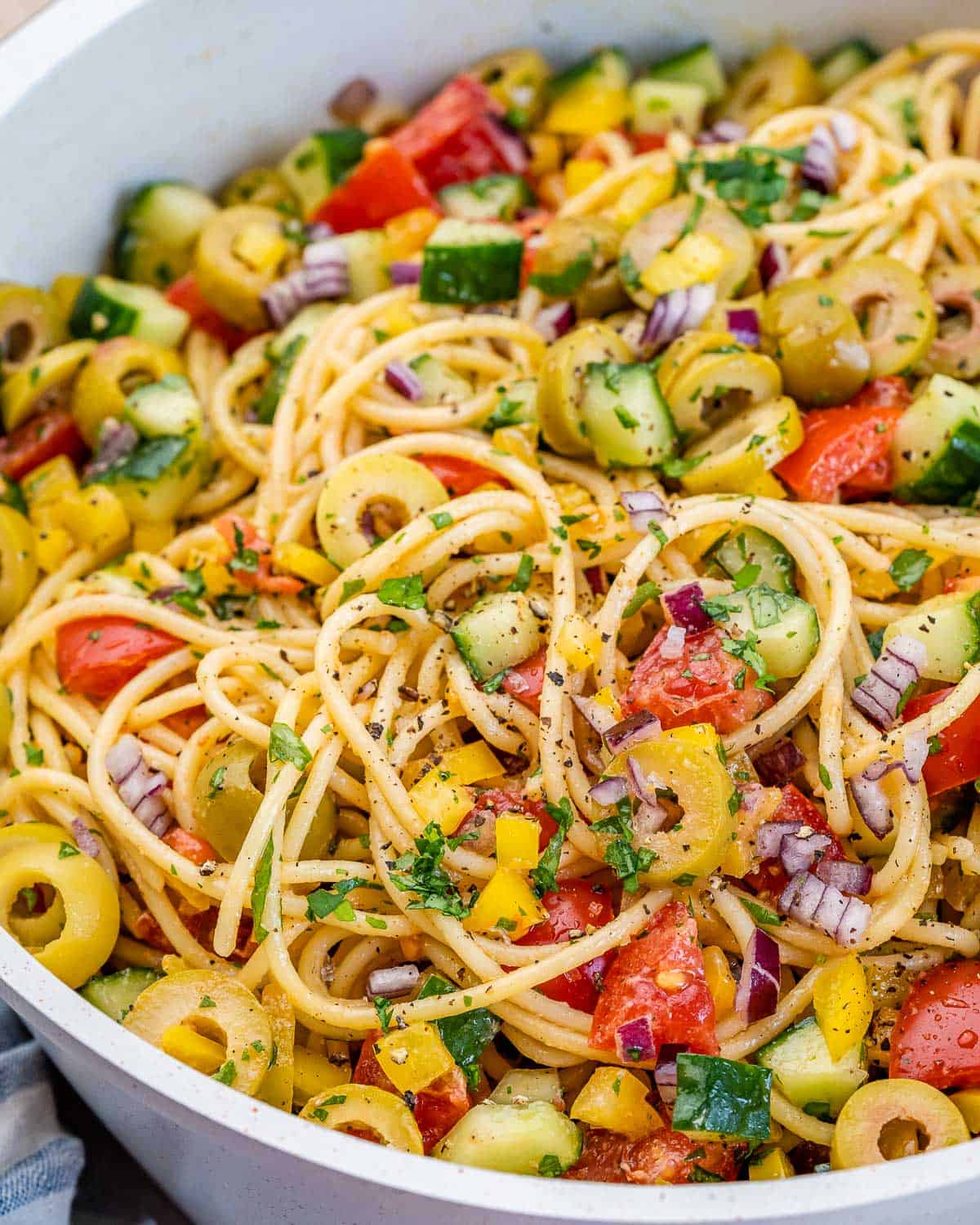 salad in a dish made with chopped veggies and spaghetti salad.