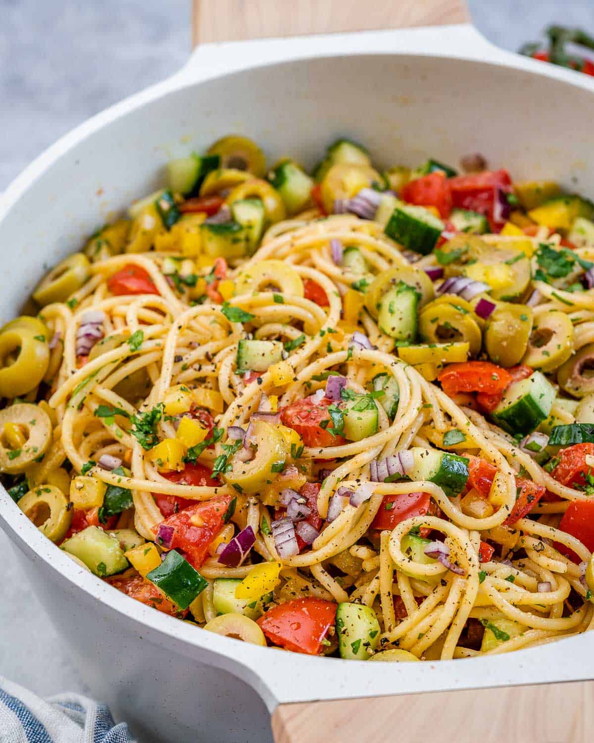 a dish with spaghetti salad made with veggies.