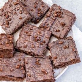 brownie square bars on a round white plate.