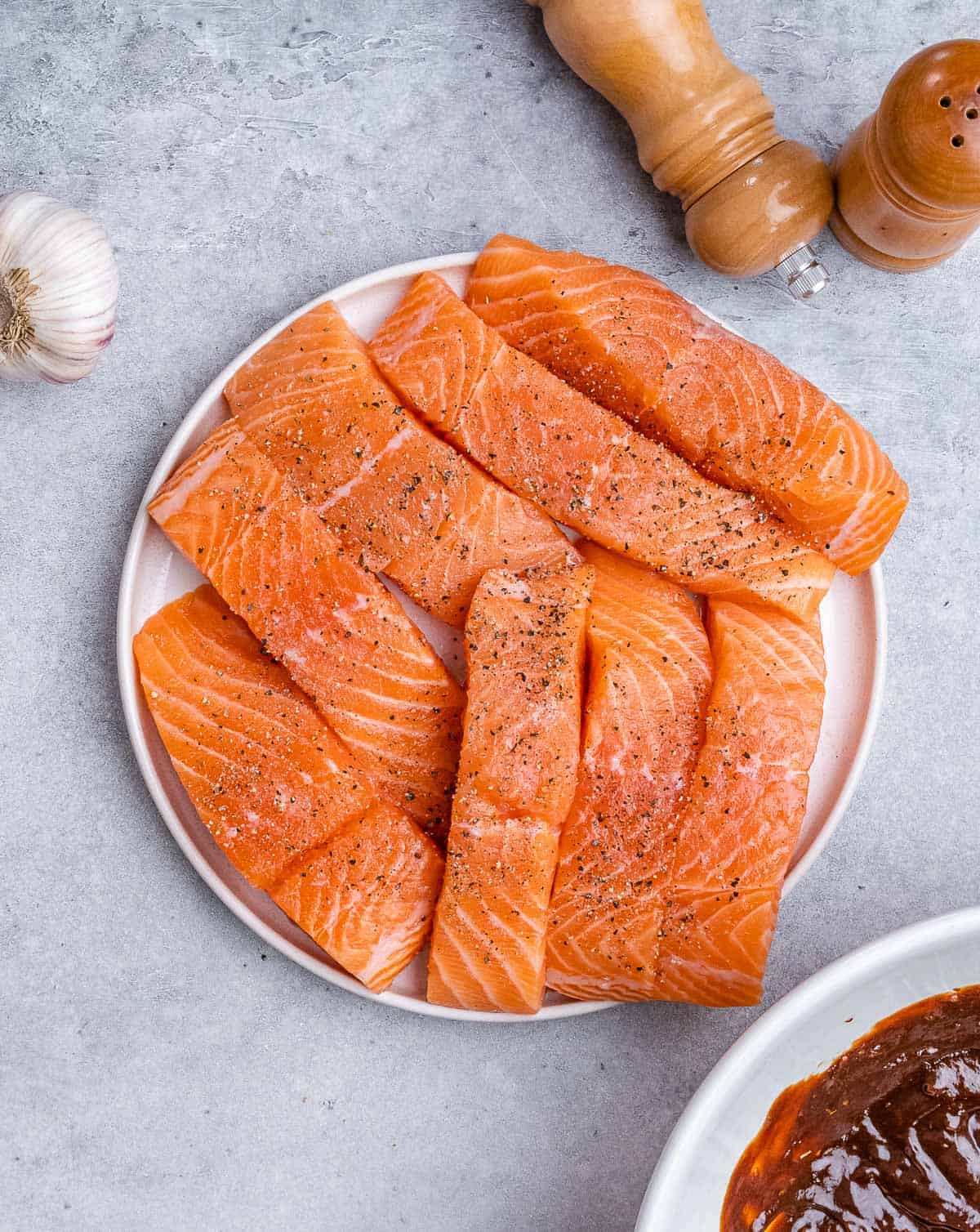 Raw salmon filets on a plate.