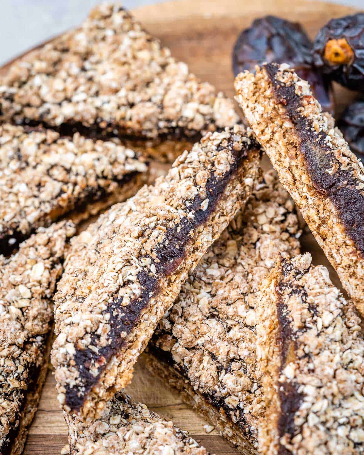 date bar squares on a brown. cutting board