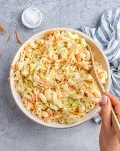 A large bowl of completed mac salad with vibrant colors and creamy texture, perfect for a family meal.