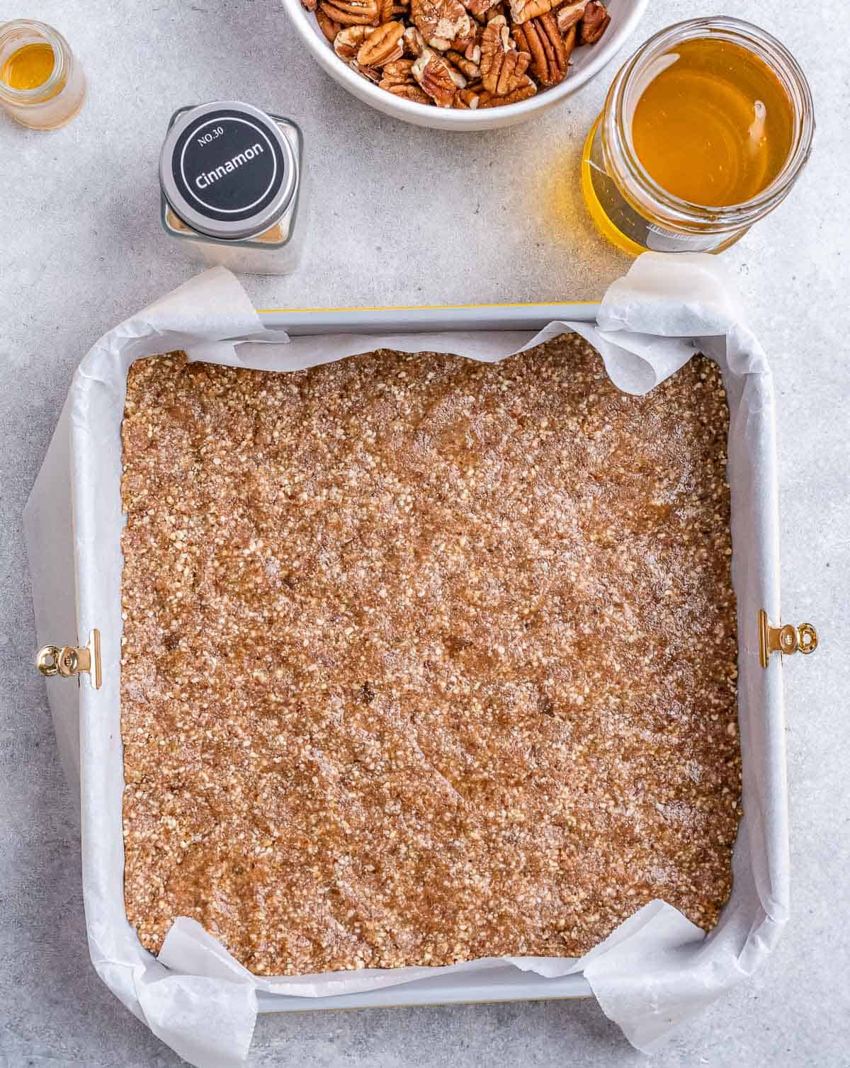 Almond flour crust pressed into a square pan.