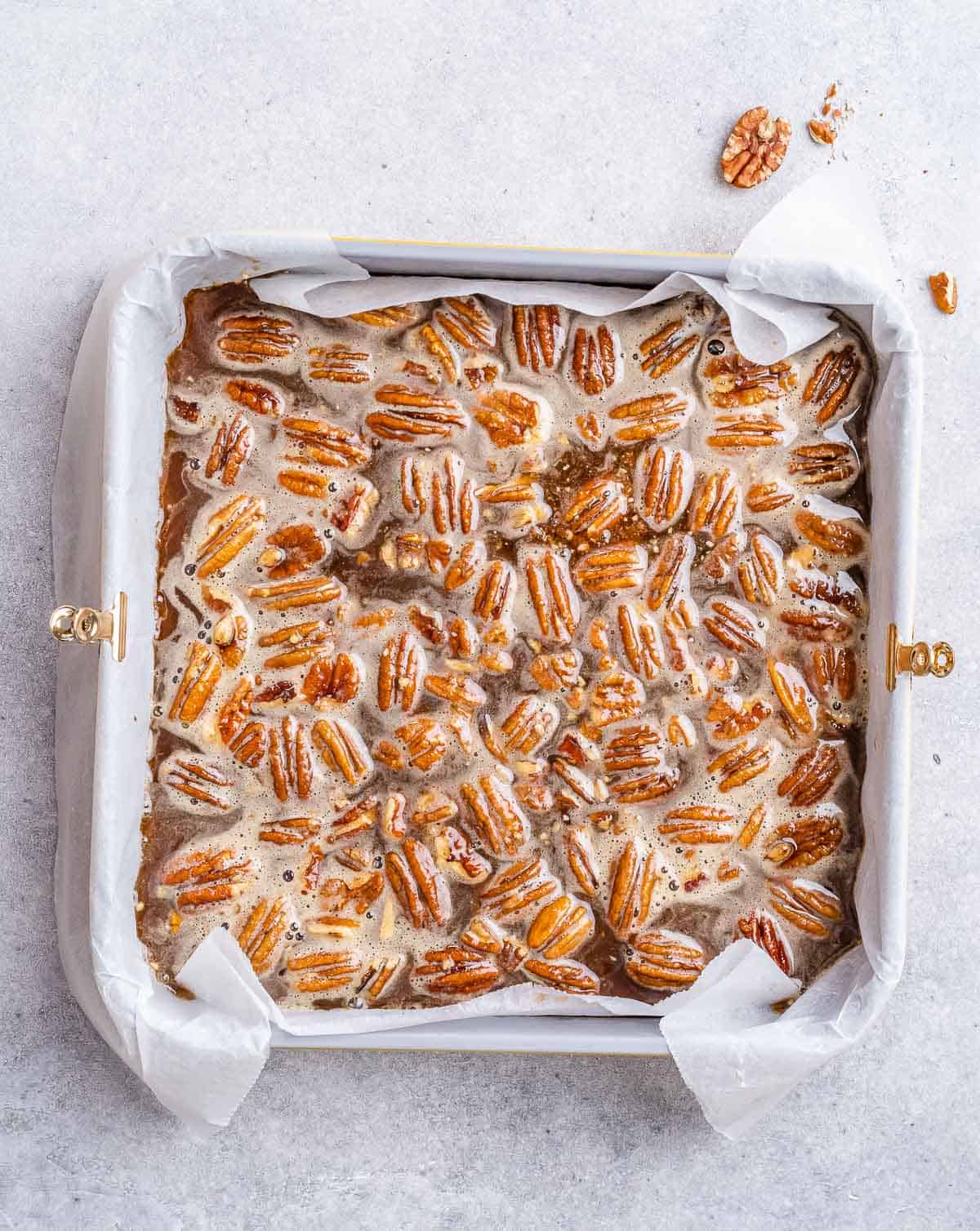 Pecan pie bars in a square pan.