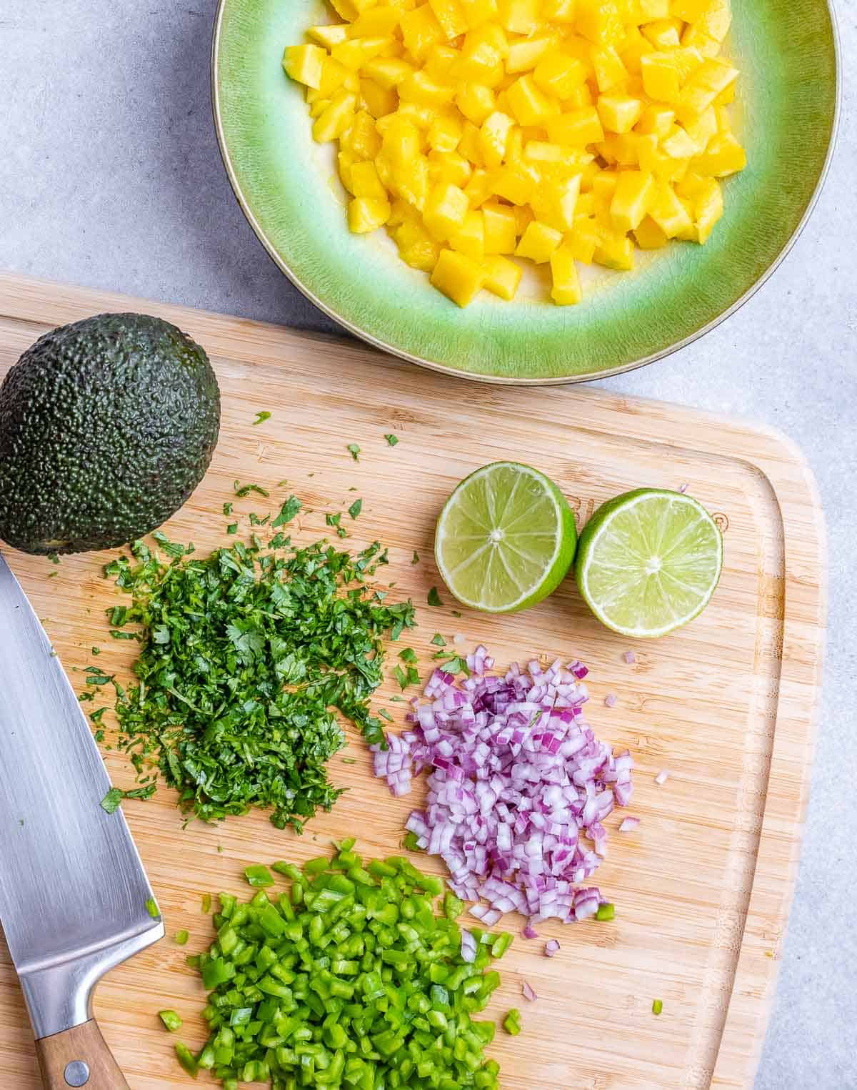 chopped onions, cilantro, and veggies to be added to the mango salsa.