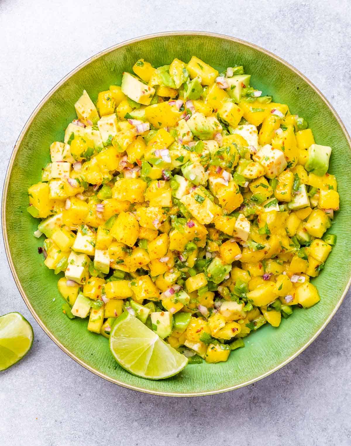 mango salsa on a round green bowl.