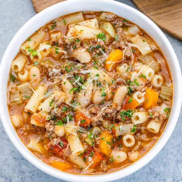 pasta soup with minced meat and veggies in a round bowl.