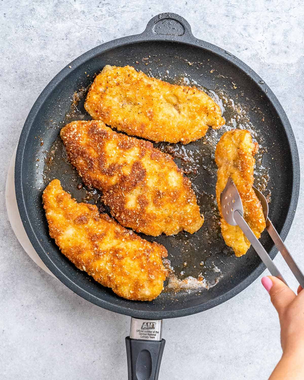 Cooking chicken in a skillet.