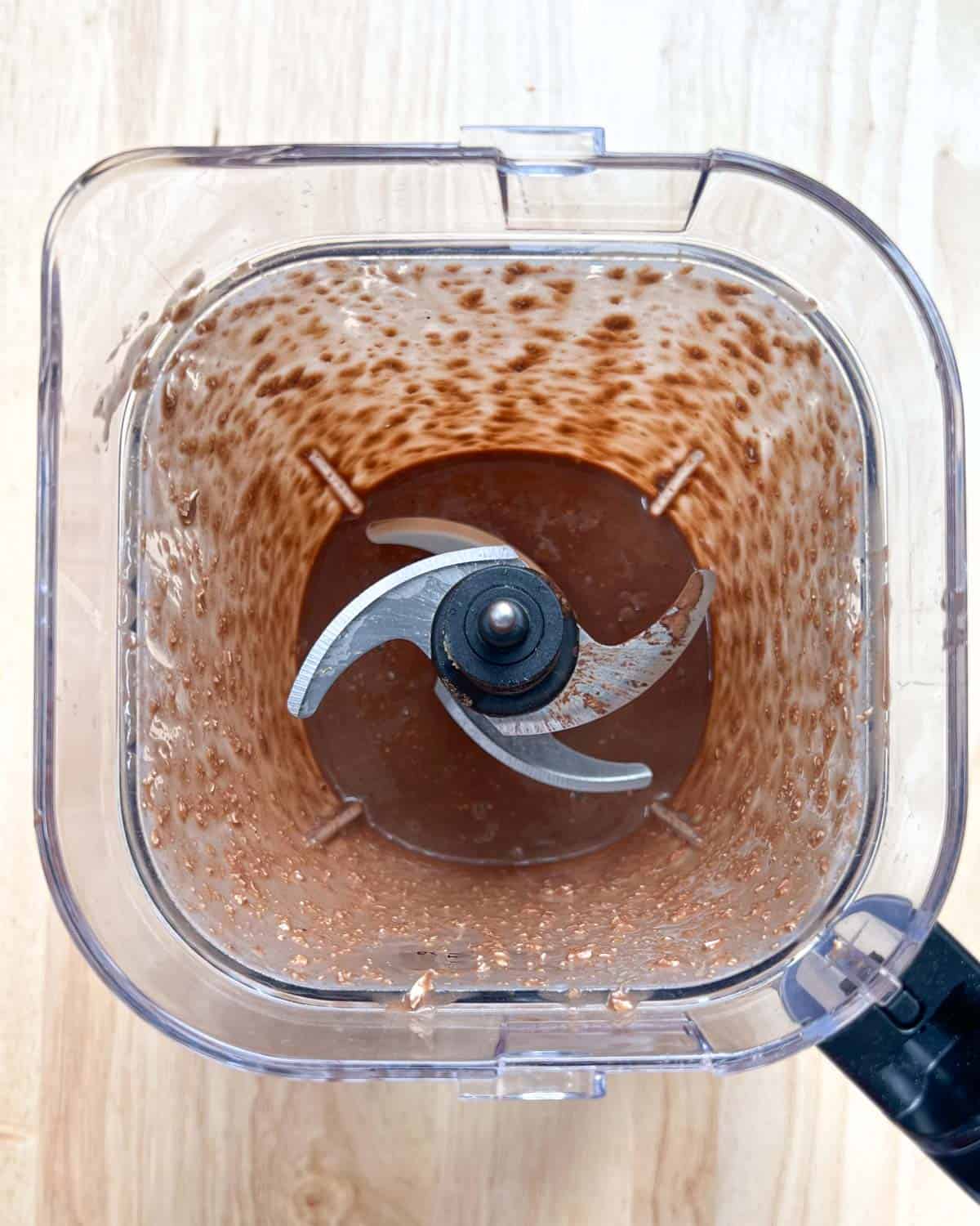 ingredients for baked oats blended into a batter in a blender.