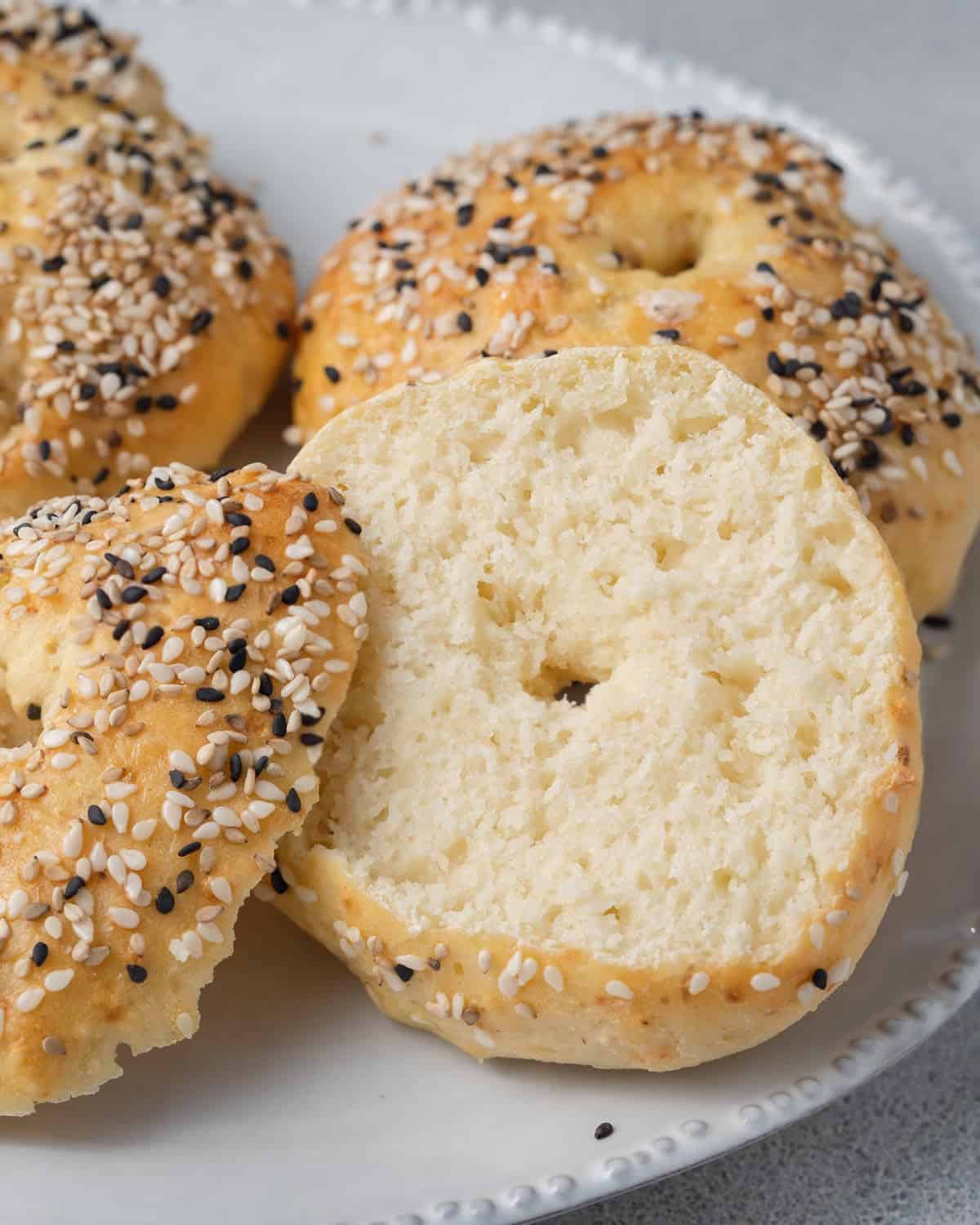  Bagel sliced in half on a plate.