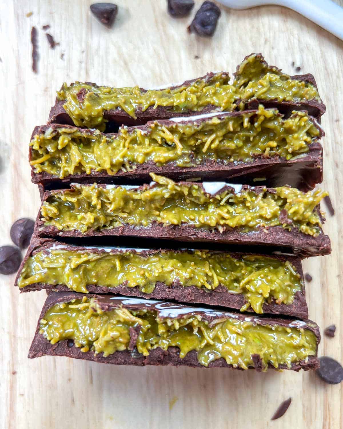 5 chocolate bar halved and placed facing up to showing the stuffed pistachio filling.