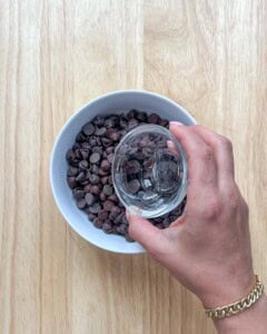 Add coconut oil to the chocolate chips in a bowl.
