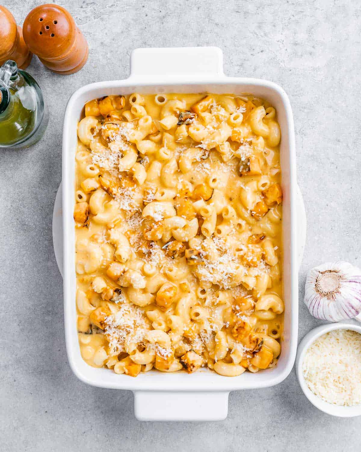 Butternut squash Mac and cheese in a white casserole dish.