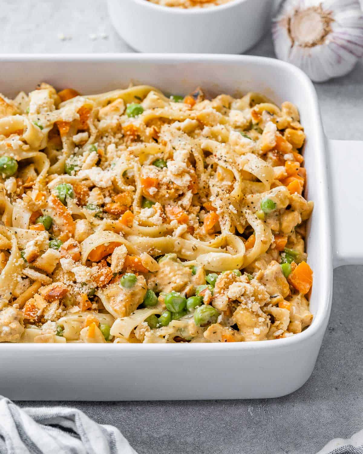 Baked Chicken Pot Pie Casserole in a white dish, topped with golden Ritz cracker crumbs and melted cheese.