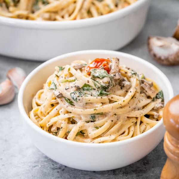 Creamy pasta in a round white bowl.