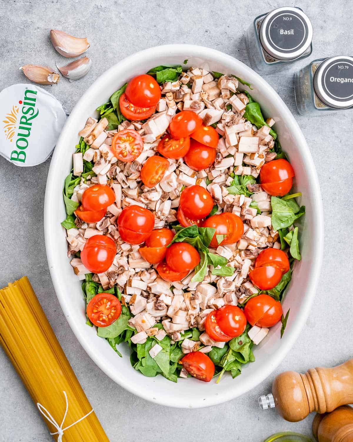 Tomato, mushroom, and spinach in a dish.