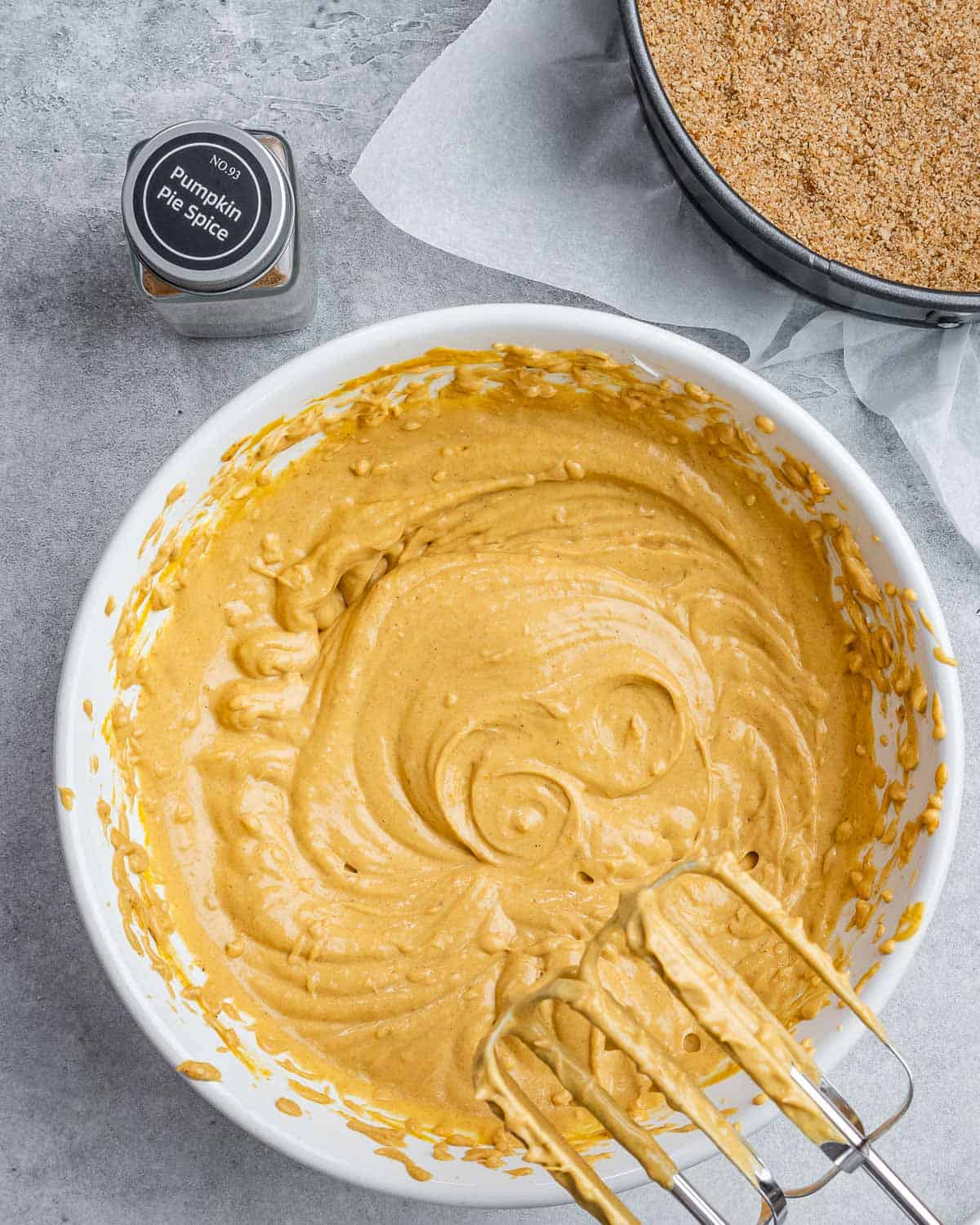 Using a mixer to beat pumpkin with cream cheese.