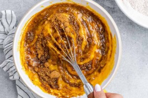 whisking the pumpkin mixture for the pumpkin banana bread.