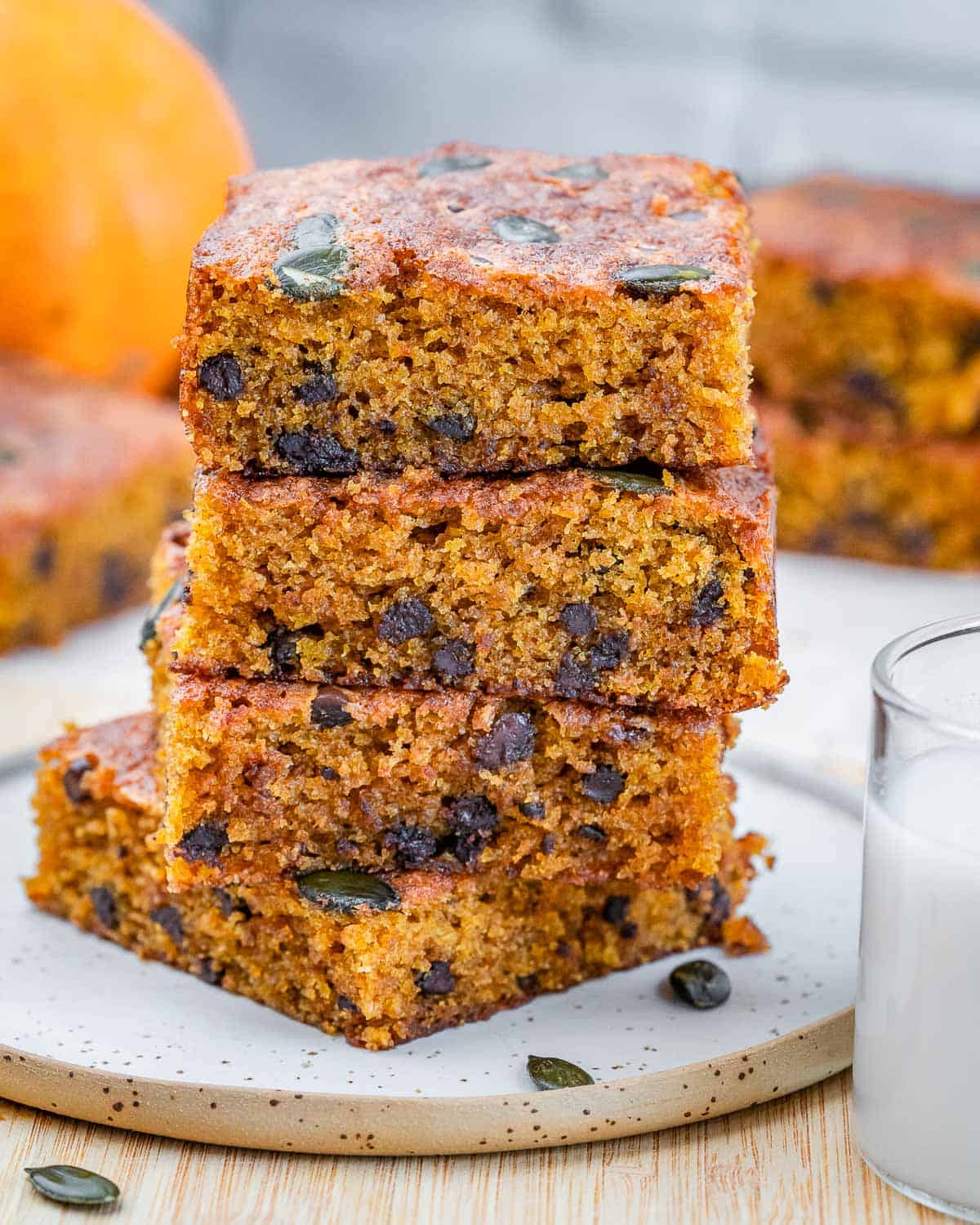 Stacks of pumpkin cake squares over each other on a plate.