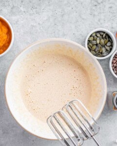 Mixing eggs and sugar with an electric mixer.
