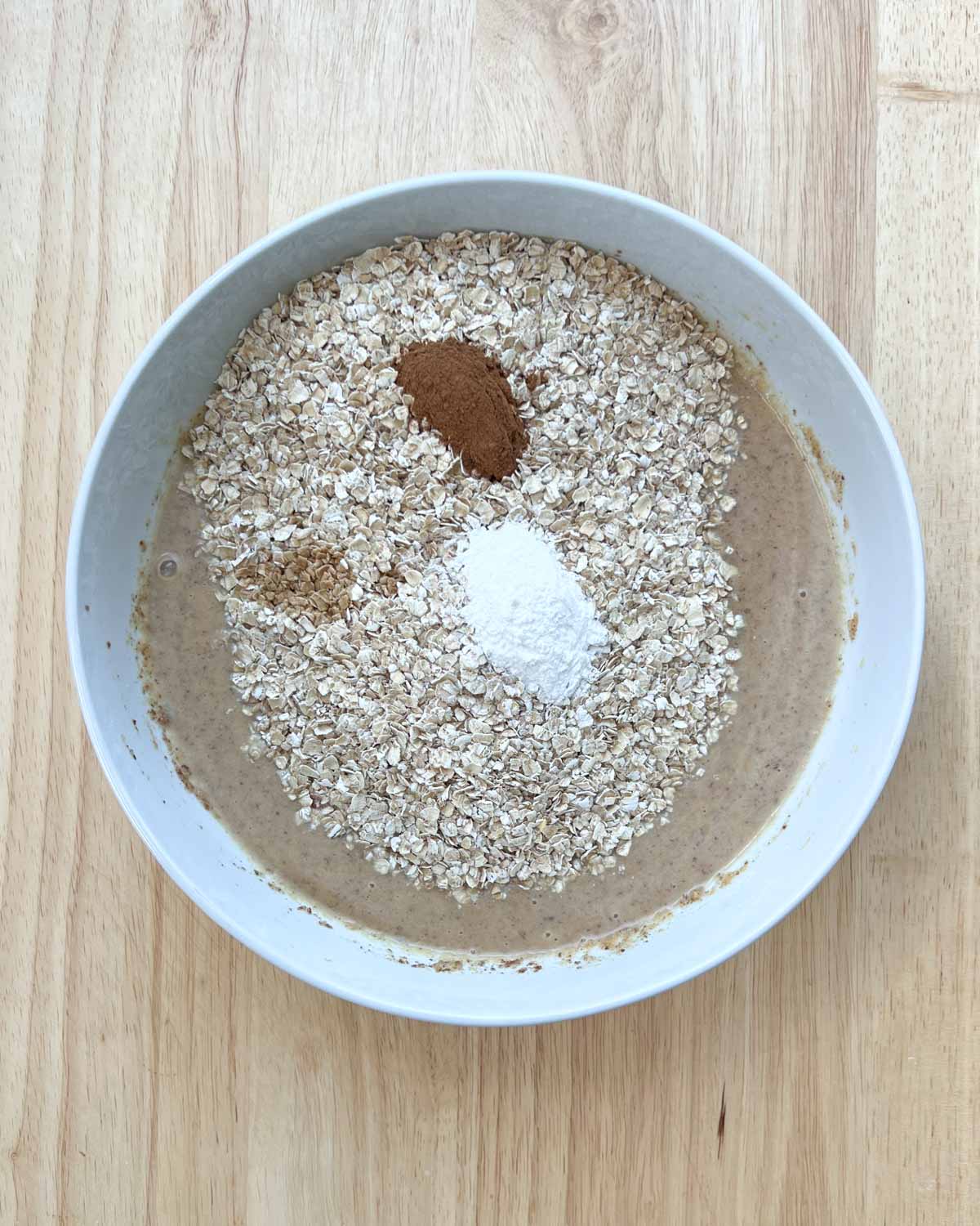 oats, baking powder, cinnamon, and vanilla are added to the peanut butter mixture.