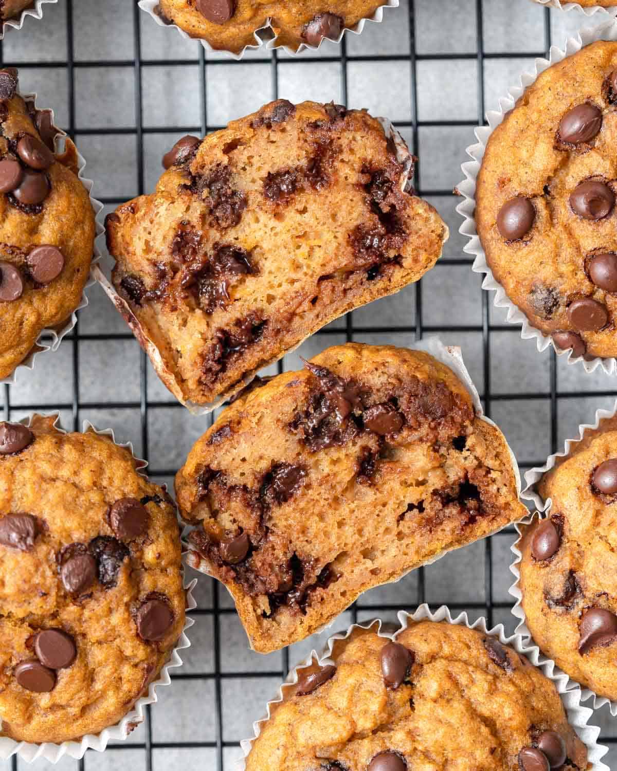 a sweet potato muffins sliced in the middle facing up on a wire wrack.