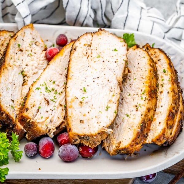 sliced cooked turkey breast on a plate.