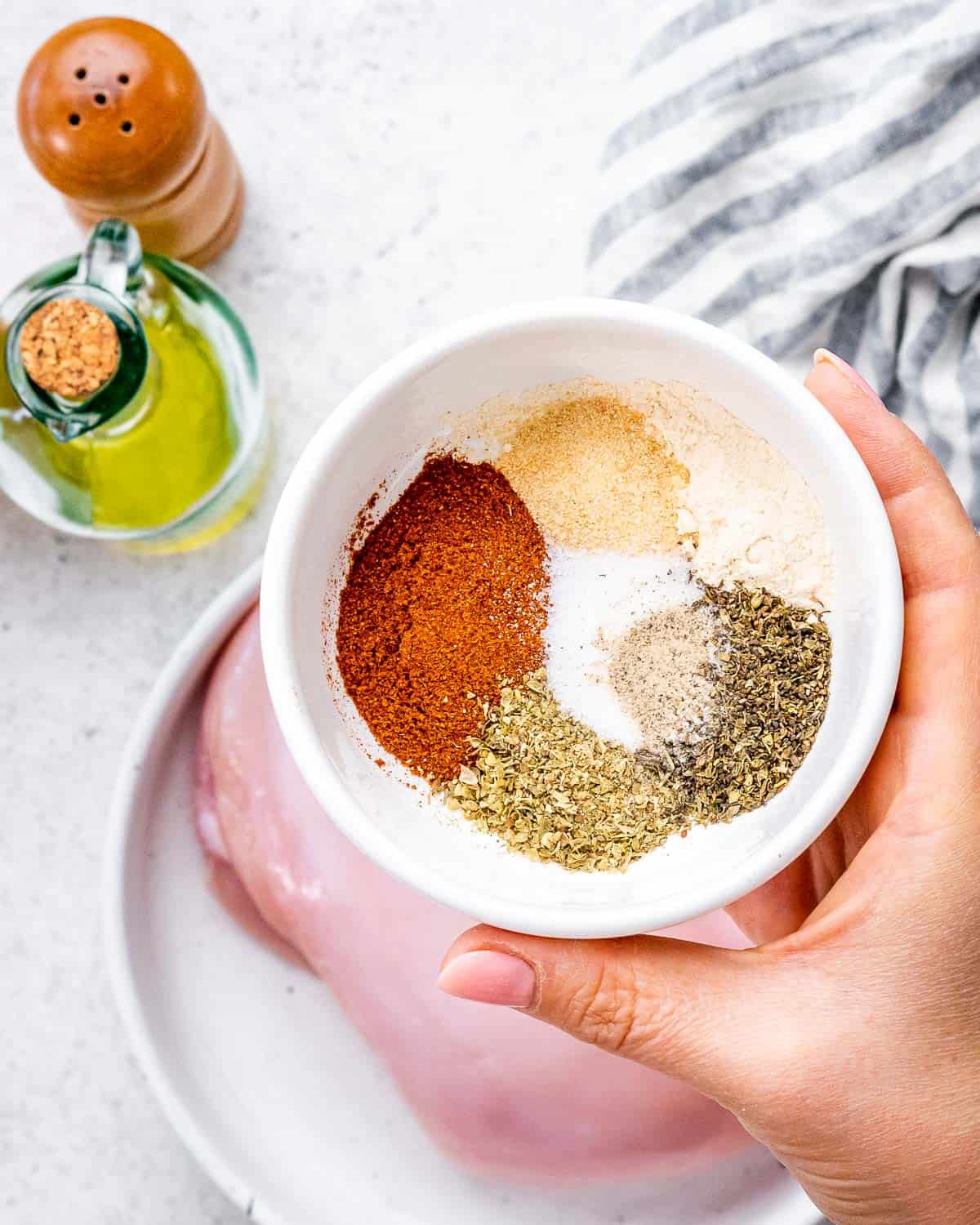 seasonings added to a small white bowl.