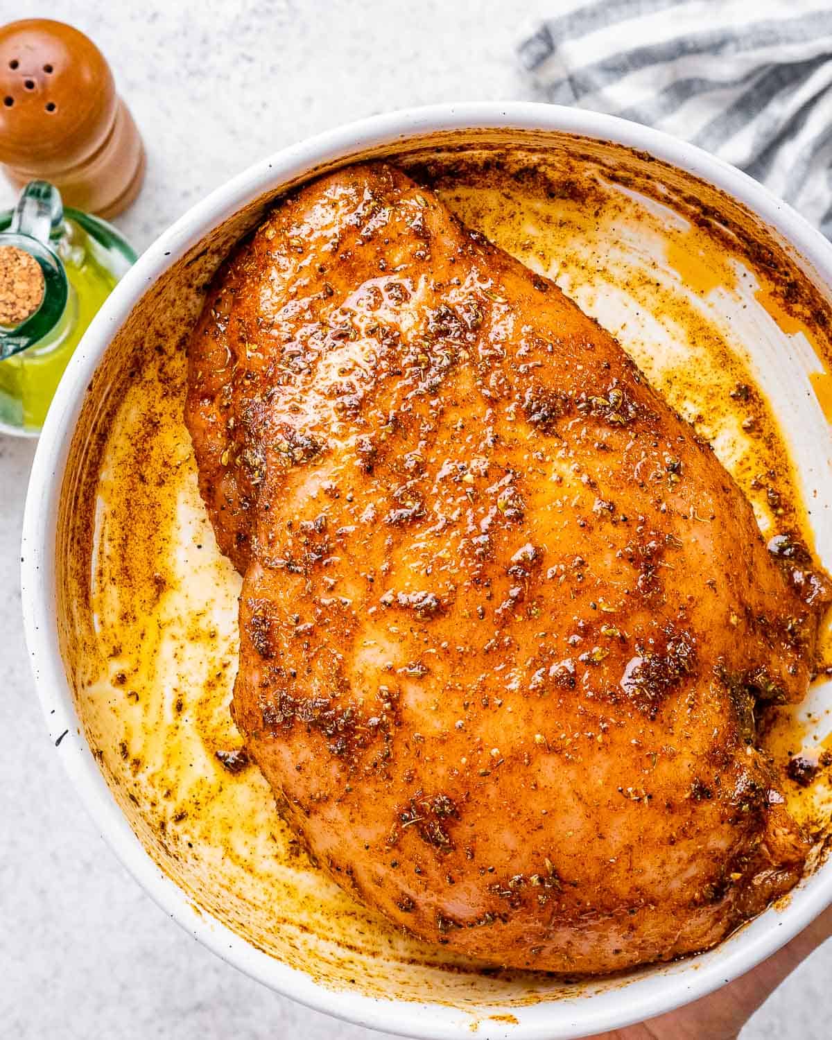 turkey breast seasoned in a plate.