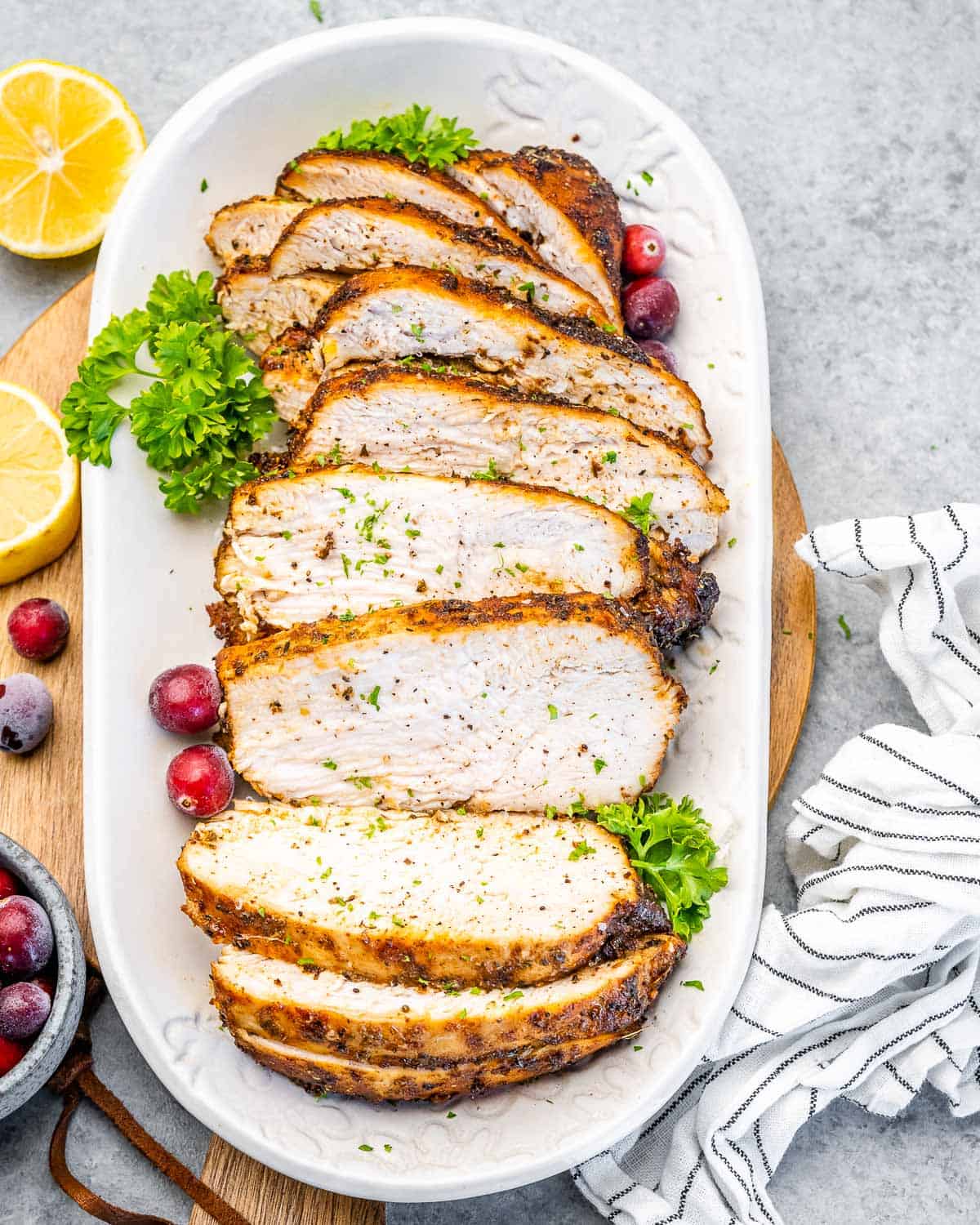 an oval plate with slices of cooked turkey breast.