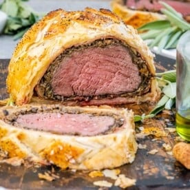 Sliced beef wellington on a cutting board.