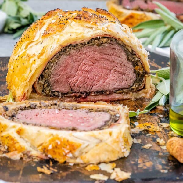 Sliced beef wellington on a cutting board.