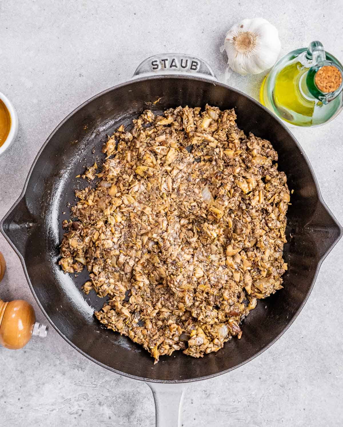 Cooking mushroom mixture in a pan.