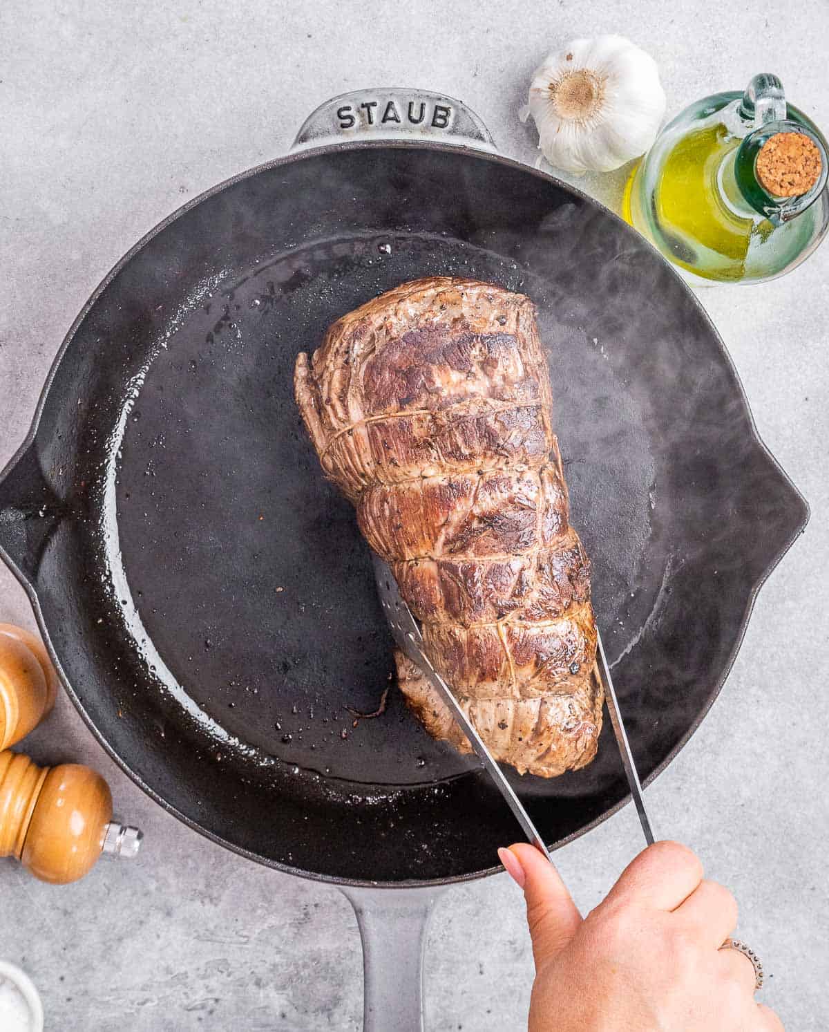 Searing beef in a pan.