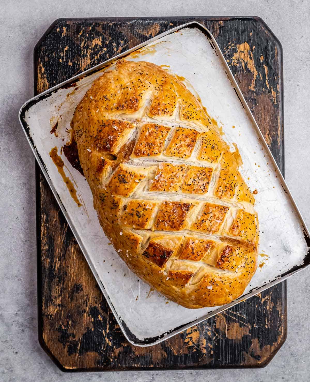 Baked Beef Wellington on a sheet pan.