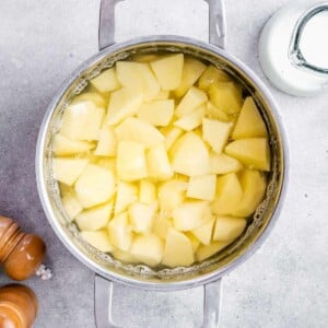 Cubed potatoes boiled in a soup pot.