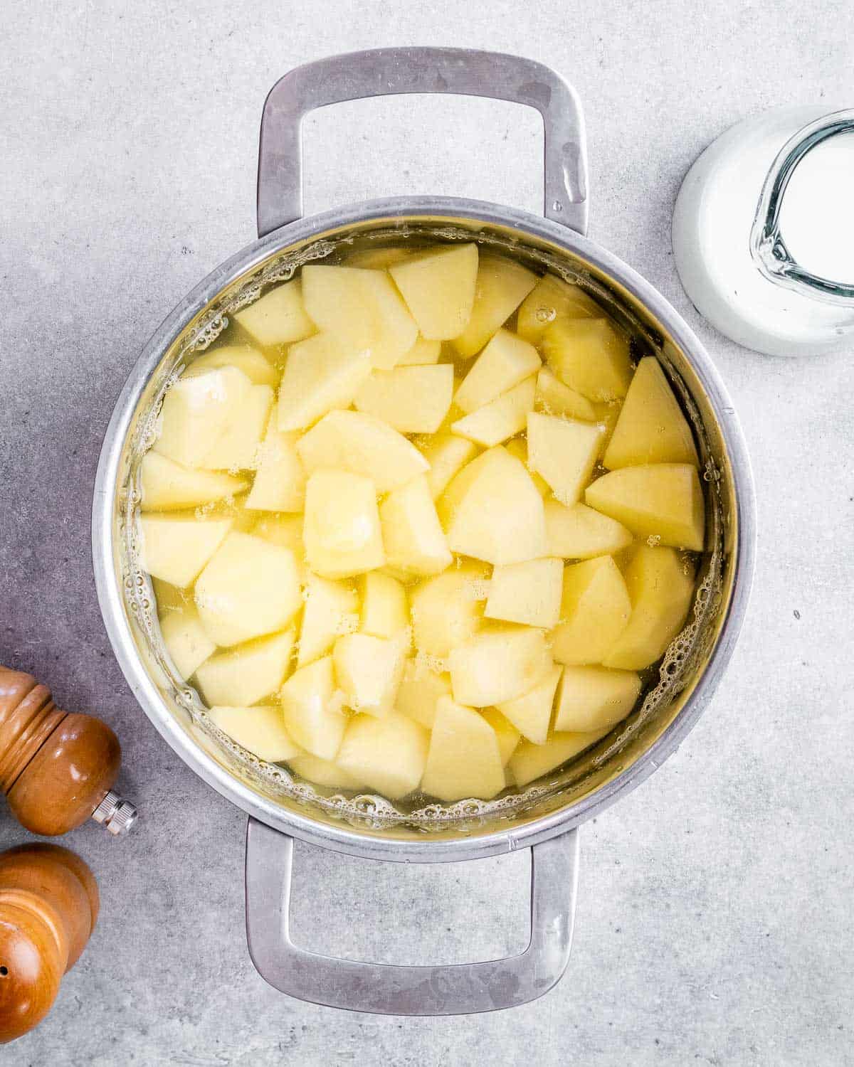 Cubed potatoes boiled in a soup pot.