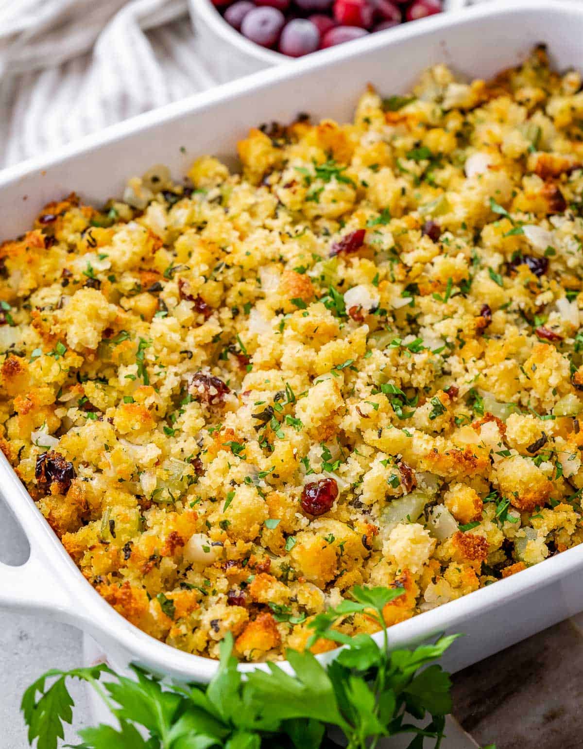 Cornbread stuffing in a large white casserole dish.