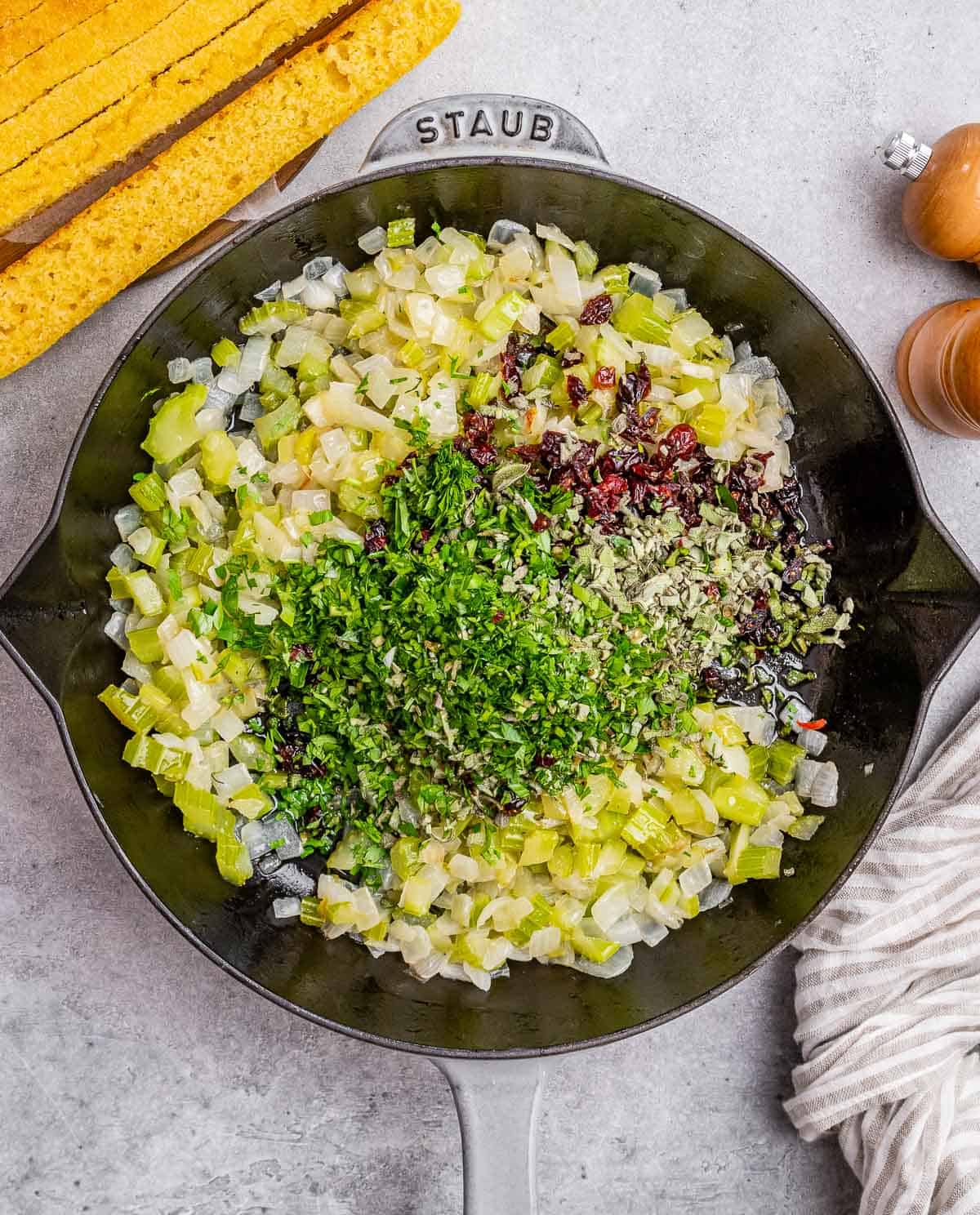 Sautéing onion and celery in a large skillet.