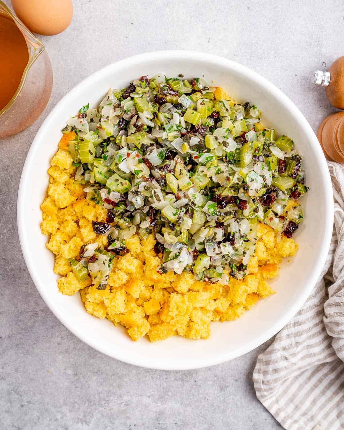 Mixing sautéed veggies with crumbled cornbread.