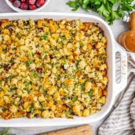 A white casserole dish with stuffing in it.