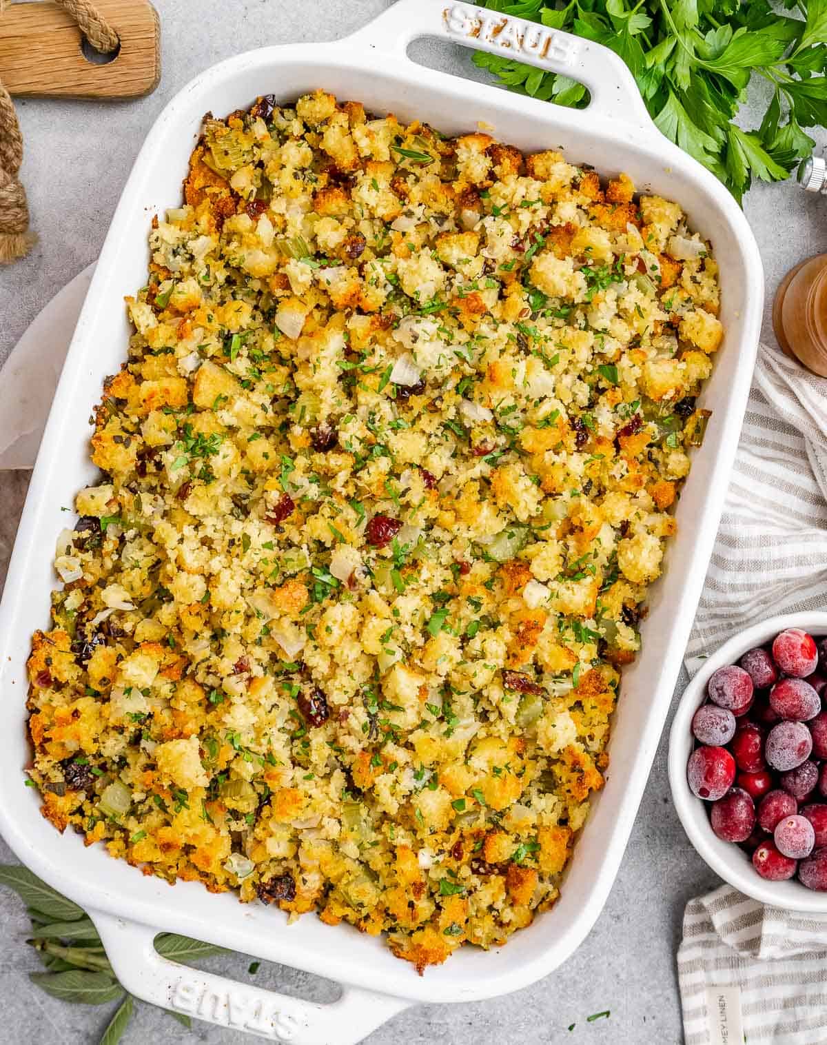 A white casserole dish with cornbread stuffing in it.