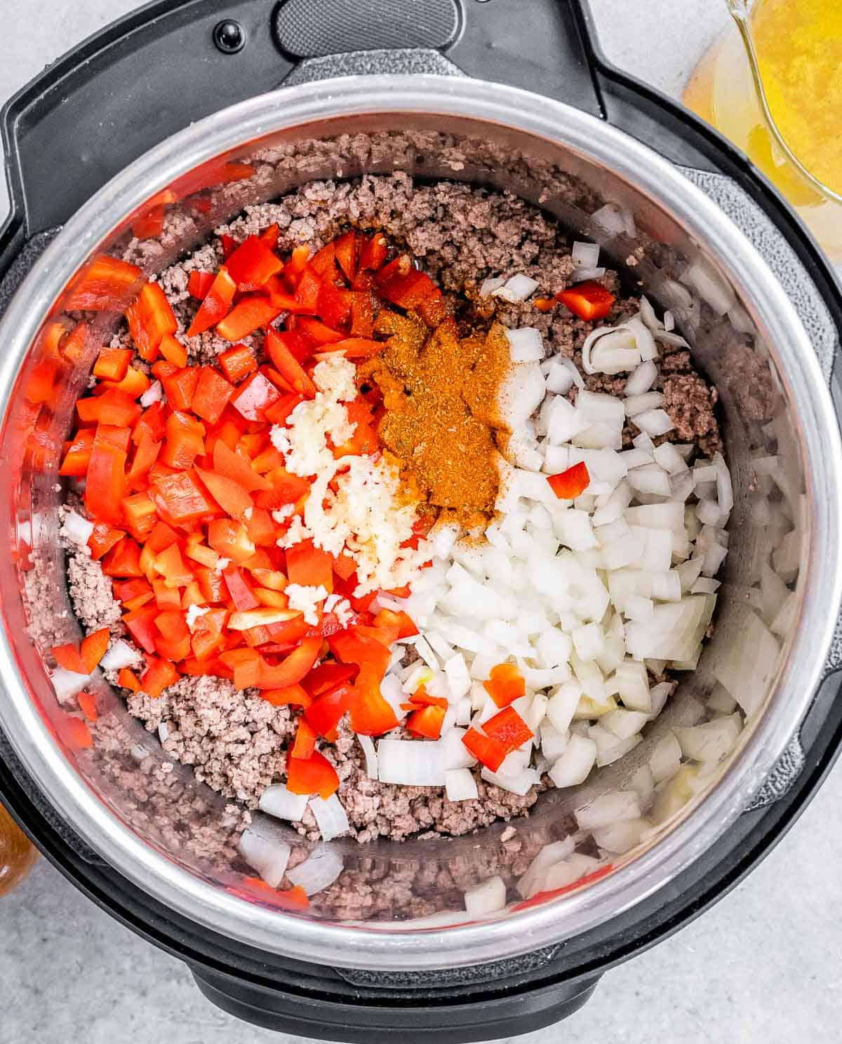 A pot with vegetables and spices.