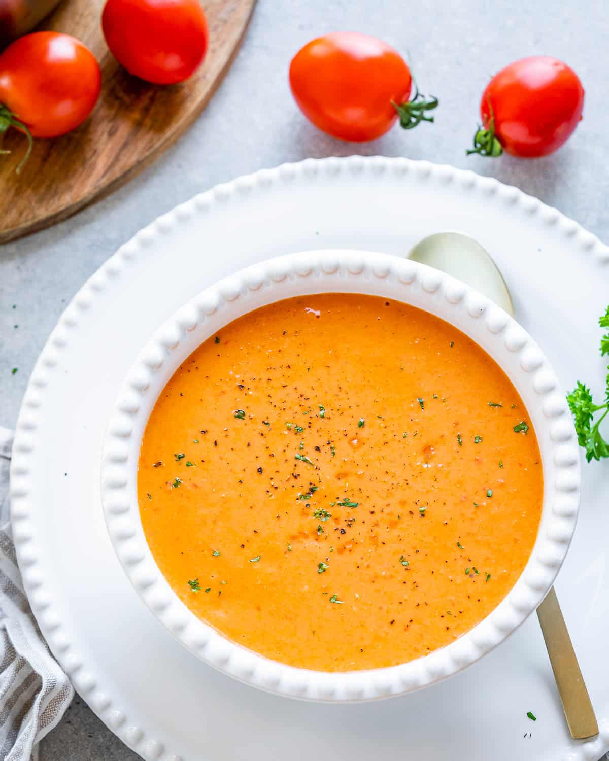 A bowl full of orange-looking tomato soup.