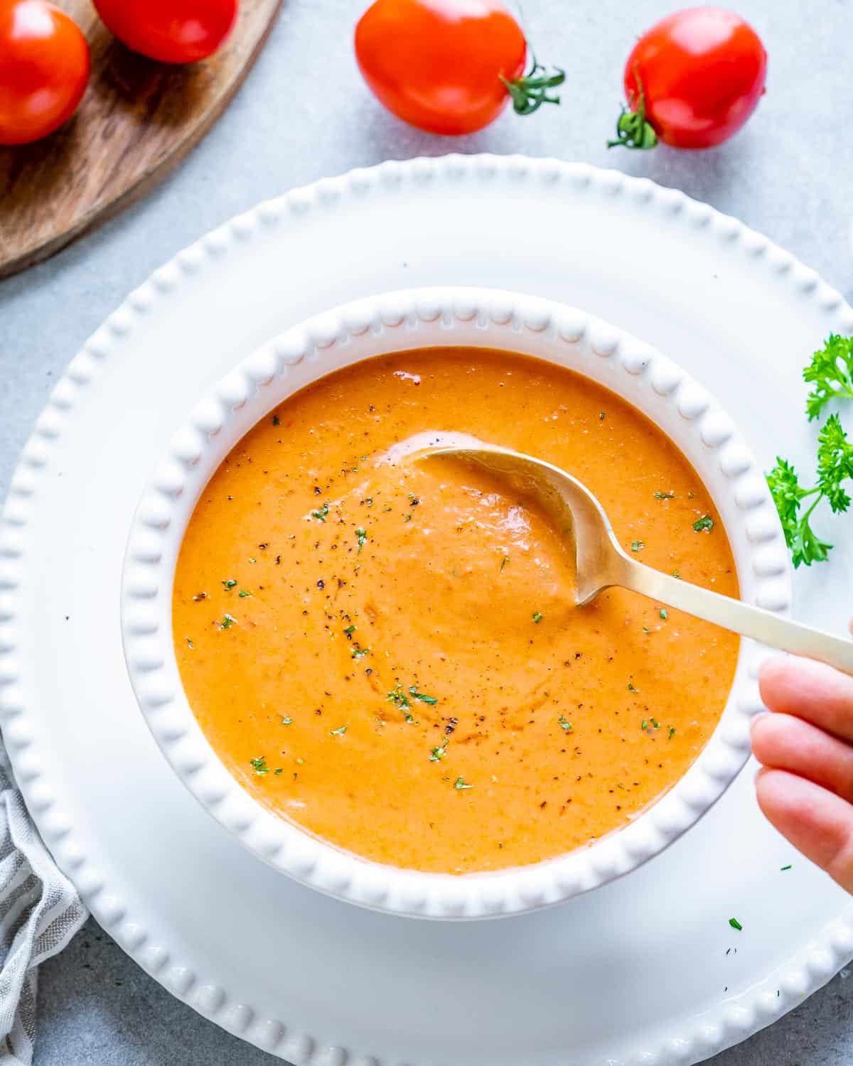 a white bowl of soup with a spoon in the bowl.