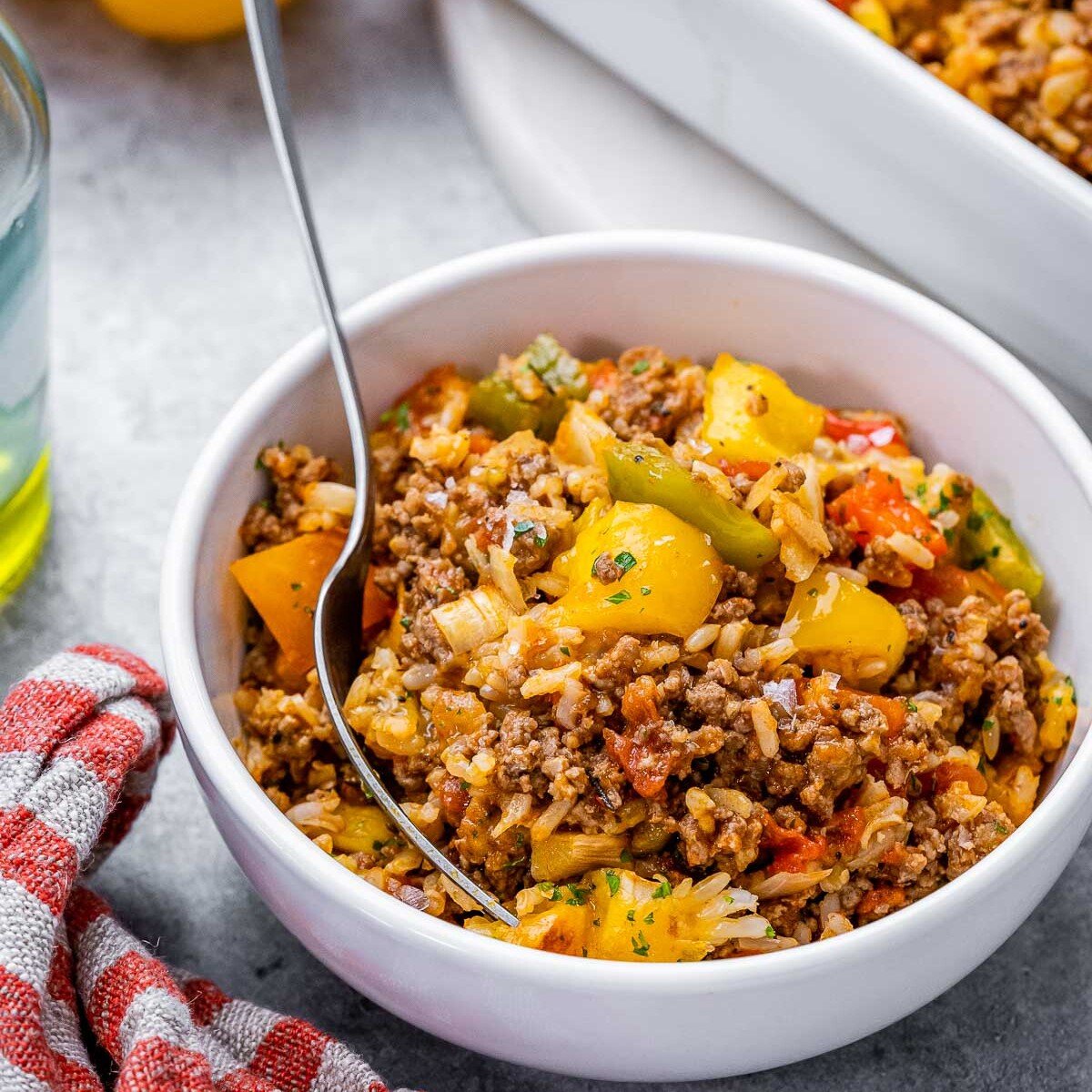  bowl with stuffed pepper casserole and a spoon in the bowl. 