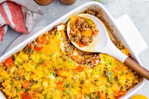top view of stuffed pepper casserole in white baking dish with spoon