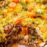 close up image of stuffed pepper casserole in white baking dish
