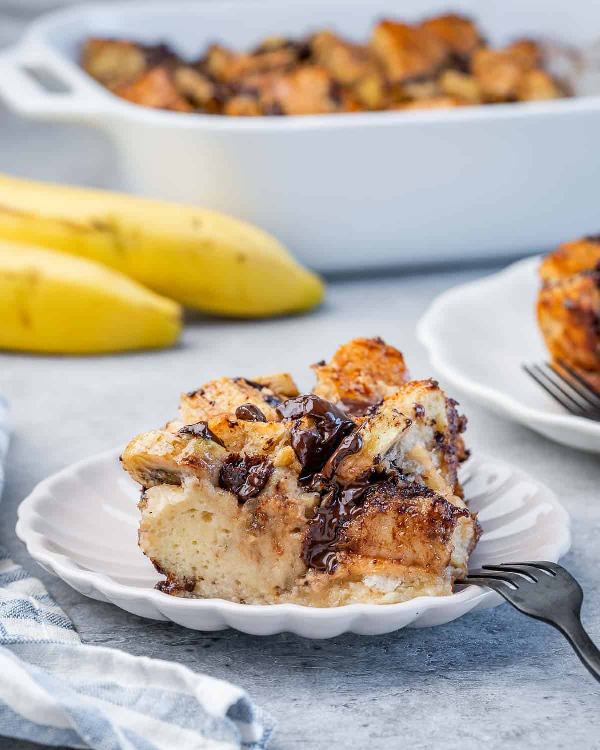 a slice of baked banana bread pudding on a plate.